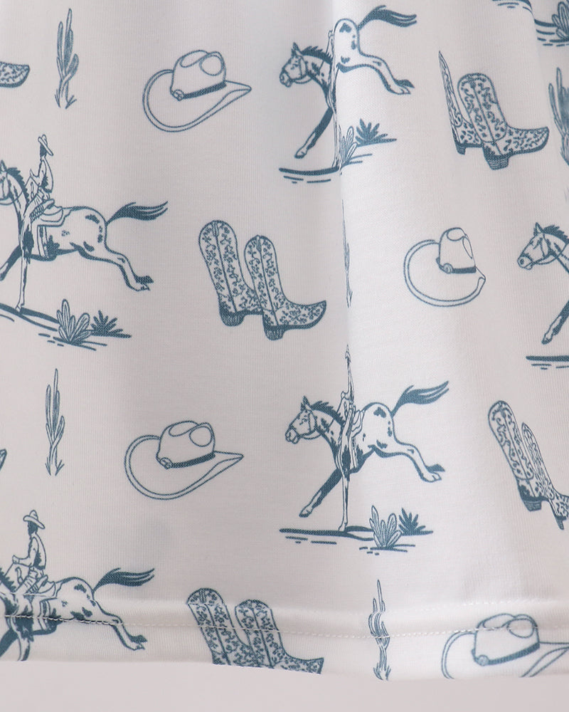 Fabric with blue western-themed patterns including boots, hats, and horses on a white background