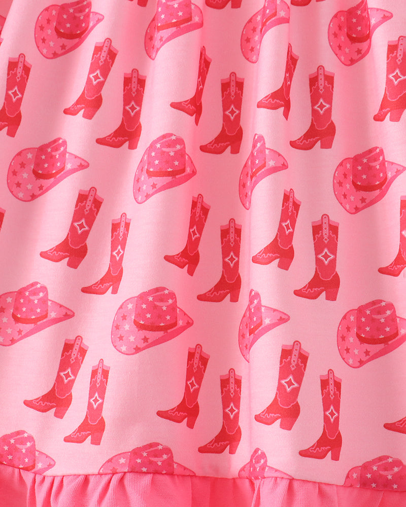 Pink fabric with an all-over cowboy boot and hat print, finished with a ruffled hem.