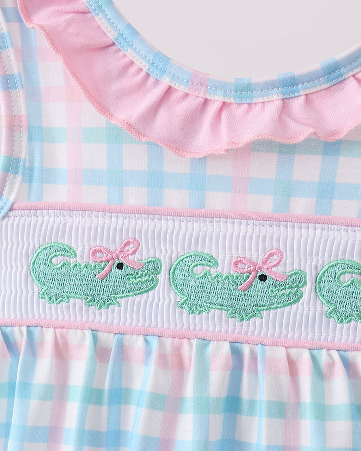 Pink-and-blue gingham baby bubble romper with green crocodile smocking and scalloped neckline