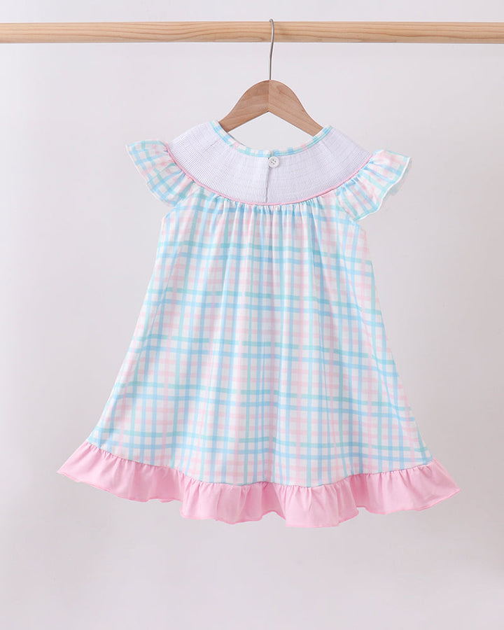 Pink-and-blue gingham smocked dress with flutter sleeves and pink ruffle hem.