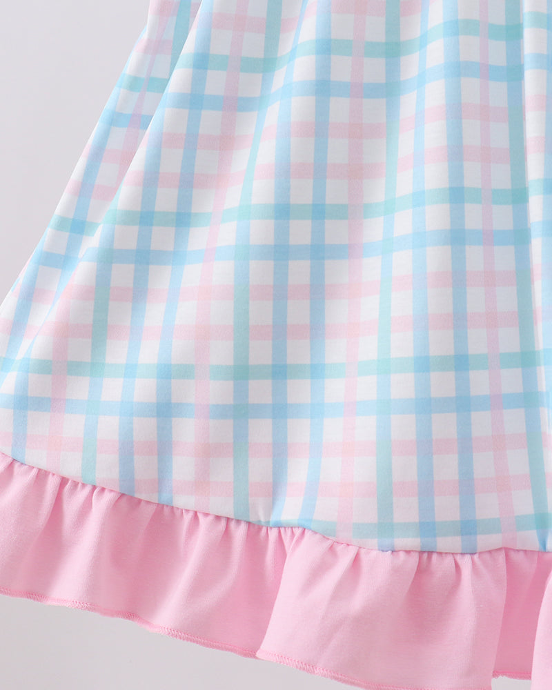 Gingham toddler dress with flutter sleeves and pink ruffle bottom, close side view.