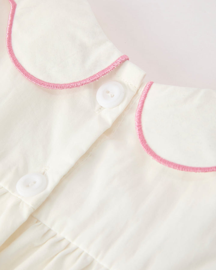 White christening dress bodice with pink-edged collar and front snap buttons
