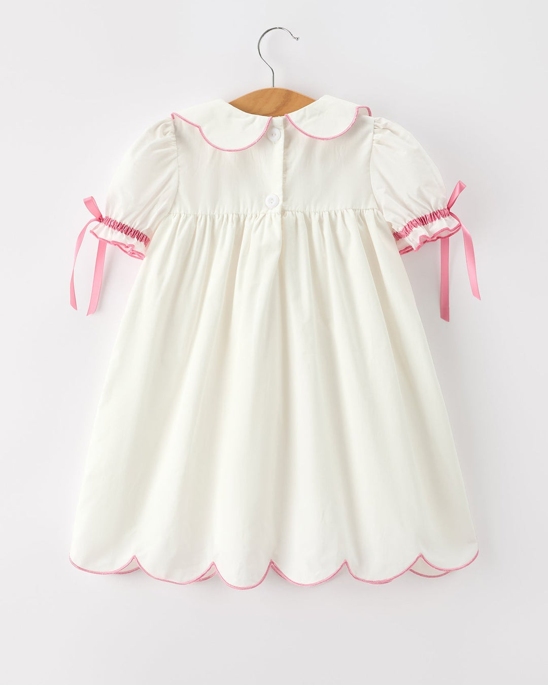 Girls cream christening dress with pink-trim Peter Pan collar and bow cuffs