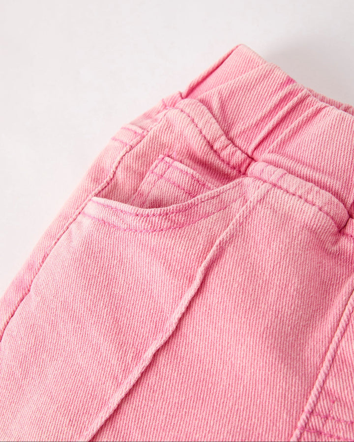Pink elastic-waist flared denim jeans close-up waistband and stitched seams