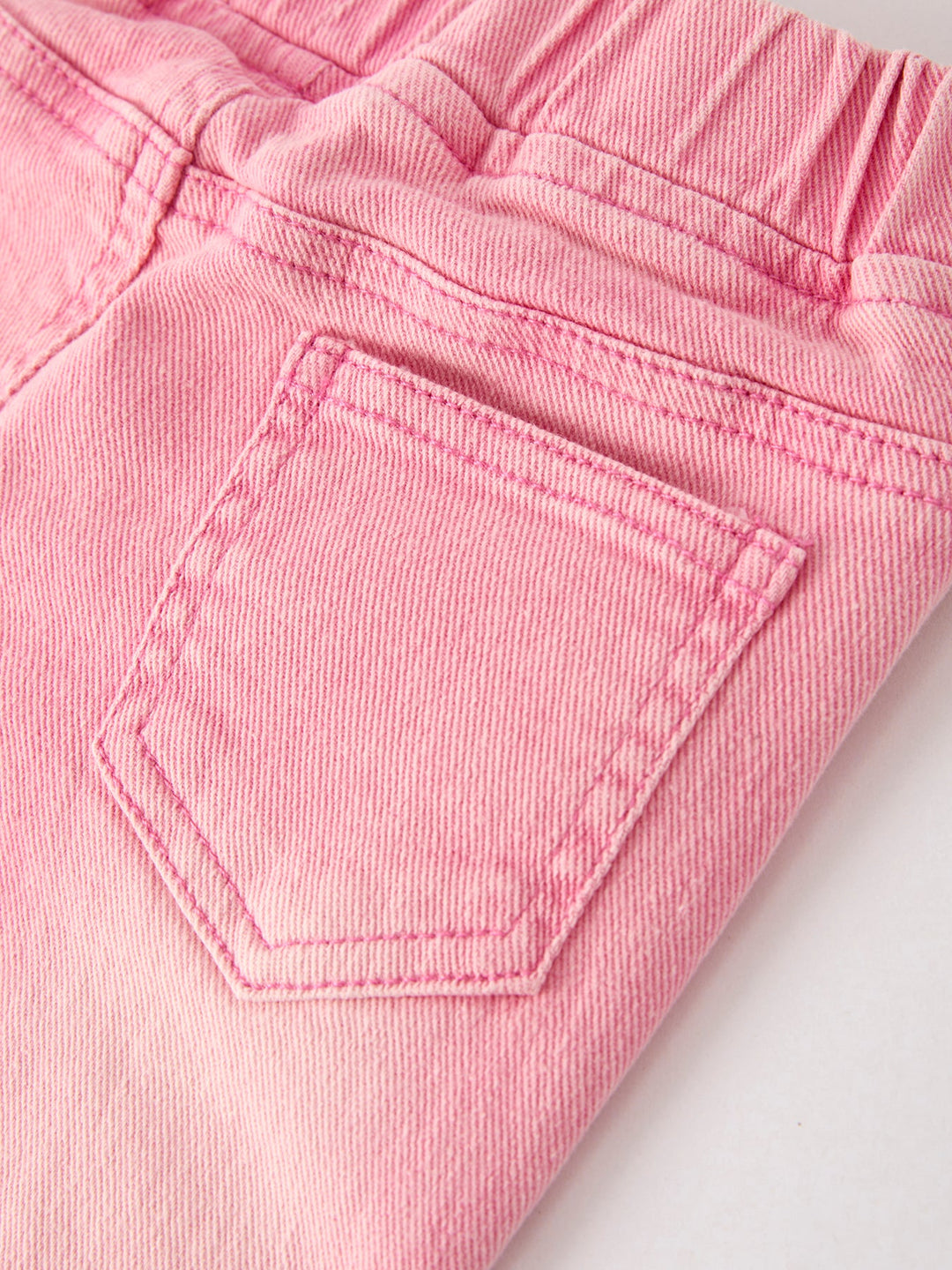 Pink flared denim jeans with stitched front pocket and elastic waistband