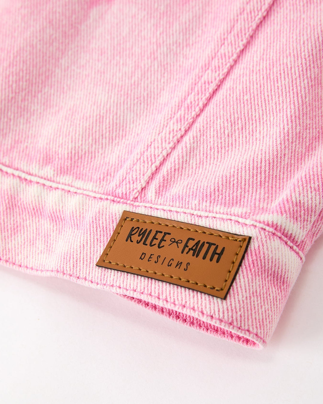 Pink denim jacket hem label patch: KILEE FAITH DESIGNS