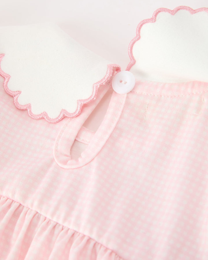 Pink scalloped collar with button closure and neck tie detail