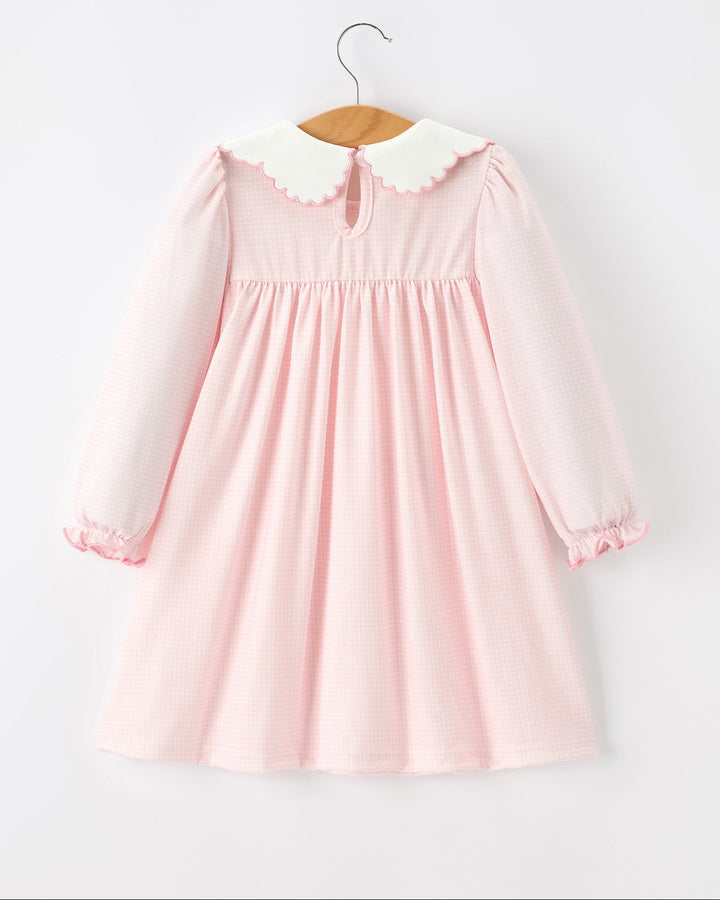 Pink baby girl dress back view with scalloped yoke, long sleeves and gathered skirt