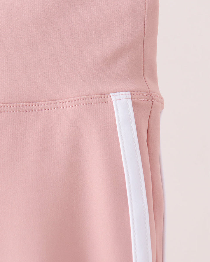 Pink active pants detail: white side stripe panel at leg opening