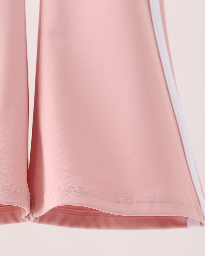 Pink flare active pants hem with curved flare and stitched edge