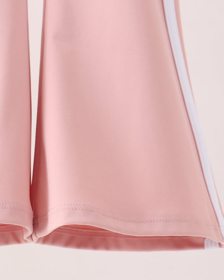 Pink flare active pants hem with curved flare and stitched edge