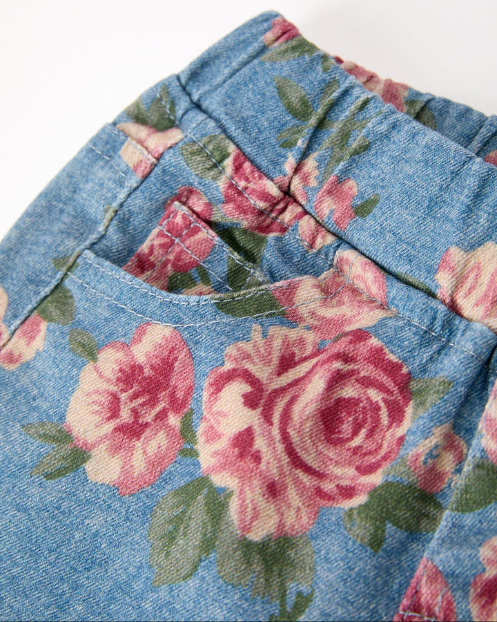 Floral denim bell-bottom pants close-up, elastic waistband and rose print