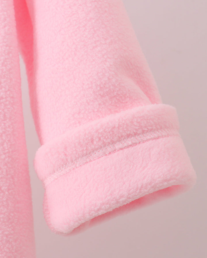 Pink fleece coat cuff with soft textured knit finish, rolled edge detail.