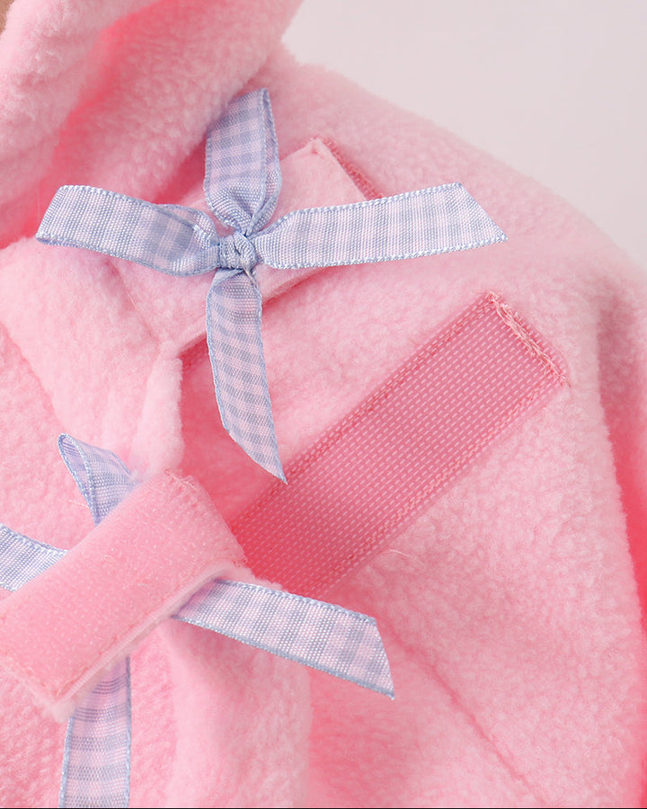 Pink fleece coat with bow applique on chest and small zippered-look pocket.