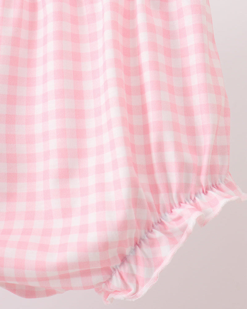 Pink and white checkered fabric on a light gray background