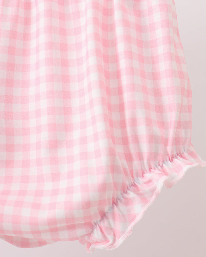 Pink and white checkered fabric on a light gray background