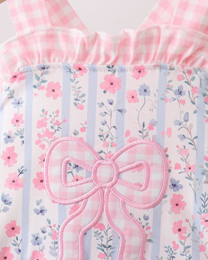 Floral patterned fabric with a large pink bow and striped design.
