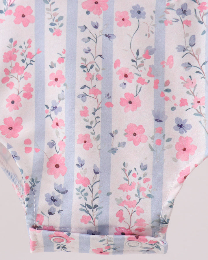 Floral patterned fabric with pink and blue flowers on a white background