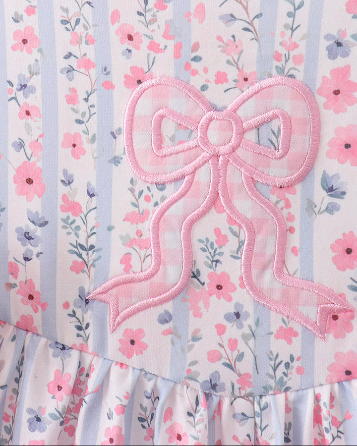 Floral dress with a large pink bow on a striped background