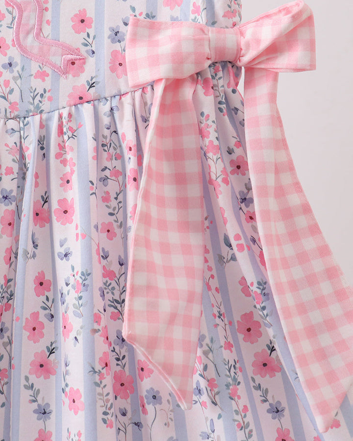 Floral and checkered fabric with a pink bow on a light background