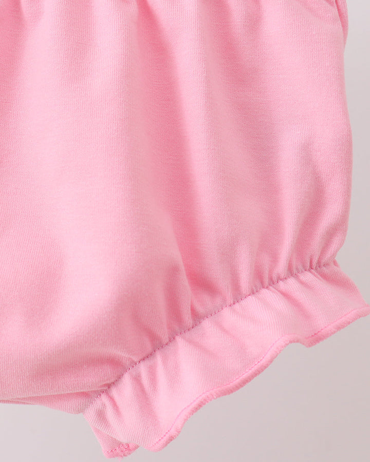 Pink baby bloomers on a light gray background