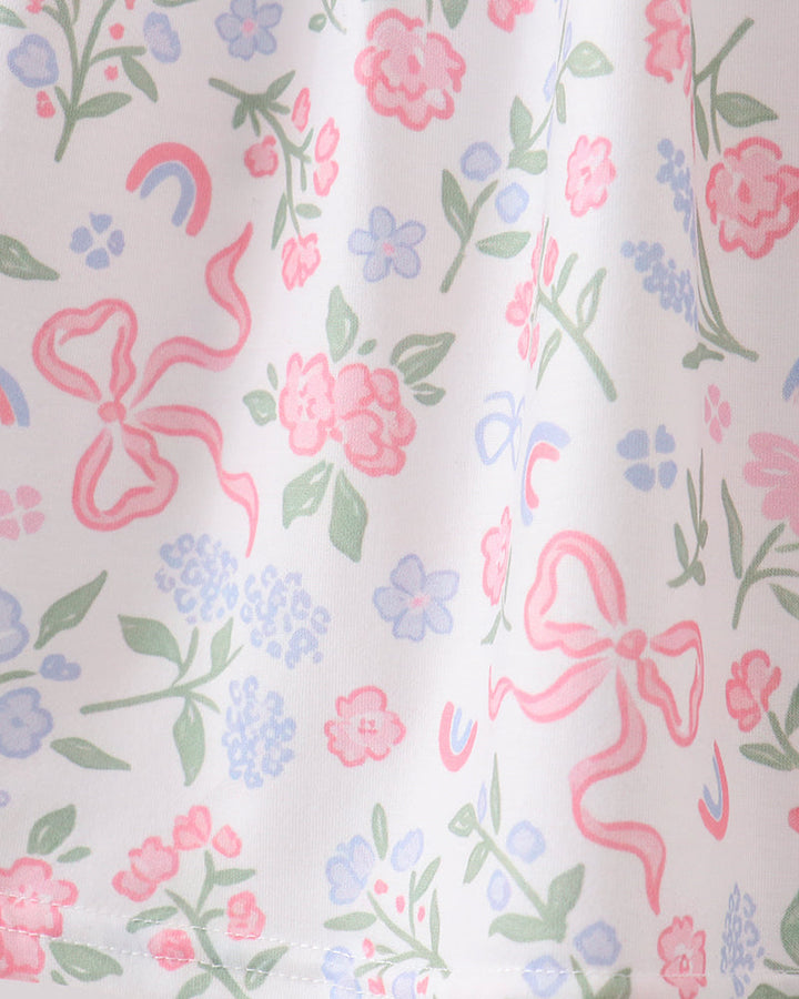 Floral and bow patterned fabric with pink bows and colorful flowers on a white background
