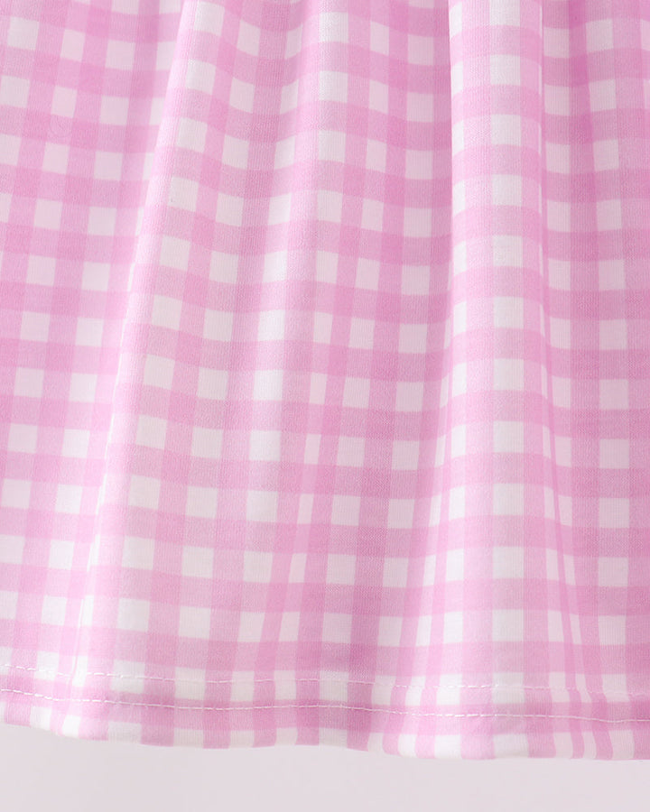 Pink and white checkered curtain on a light gray background
