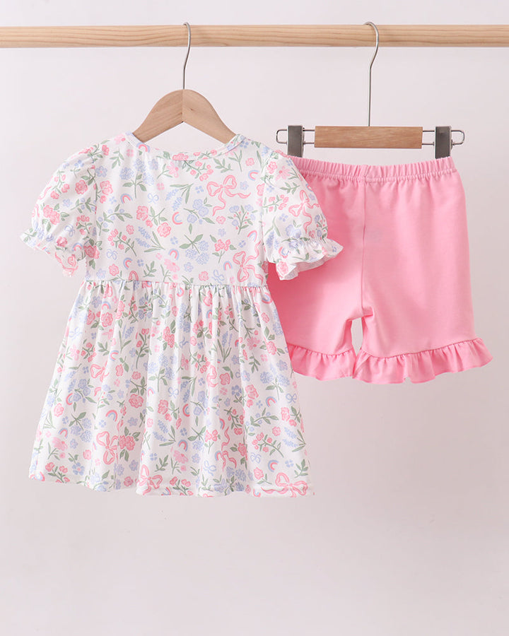 Pink Floral Bow Smocked Ruffle Shorts Set on wooden hanger.