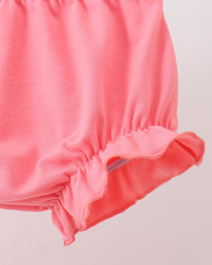 Close-up of a pink baby bloomers on a light gray background