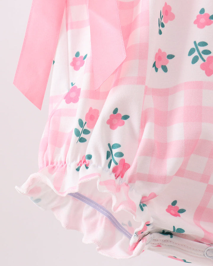 Floral-patterned fabric with a snaps on a light gray background