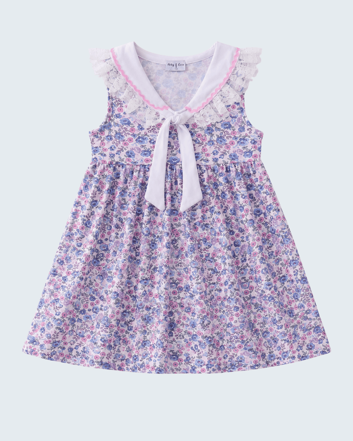 Floral dress with a bow tie on a light gray background