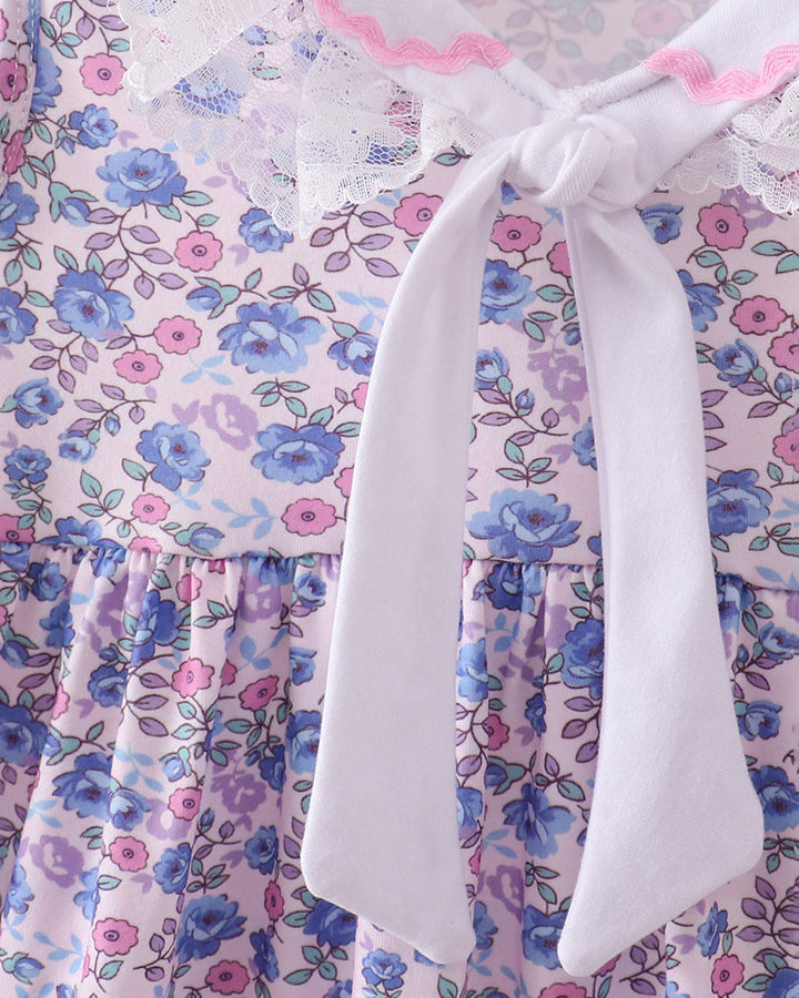 Floral dress with a white bow on a hanger