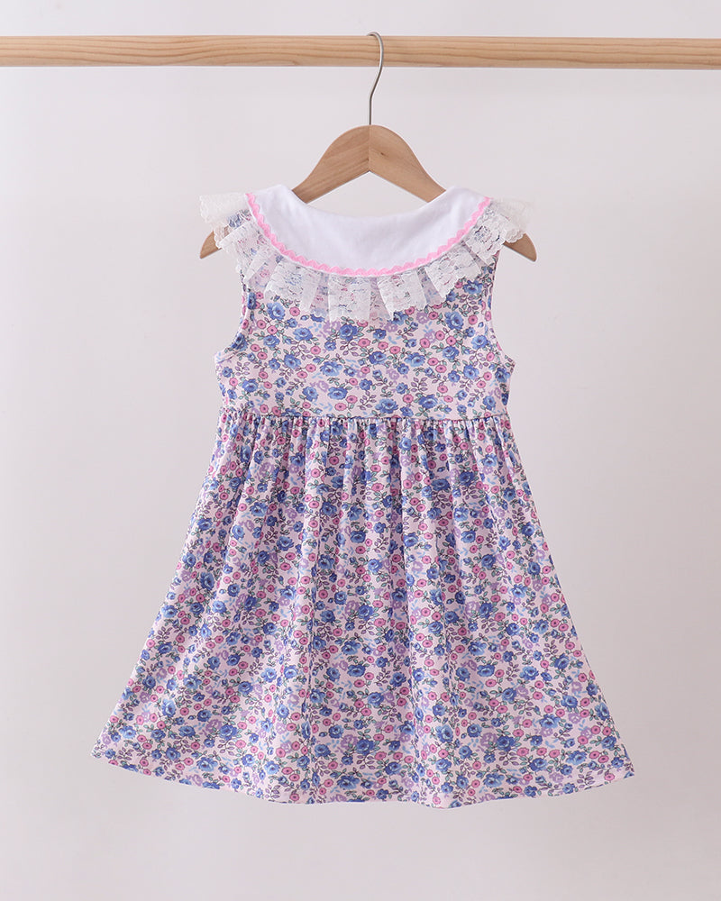 Floral dress on a hanger against a white background