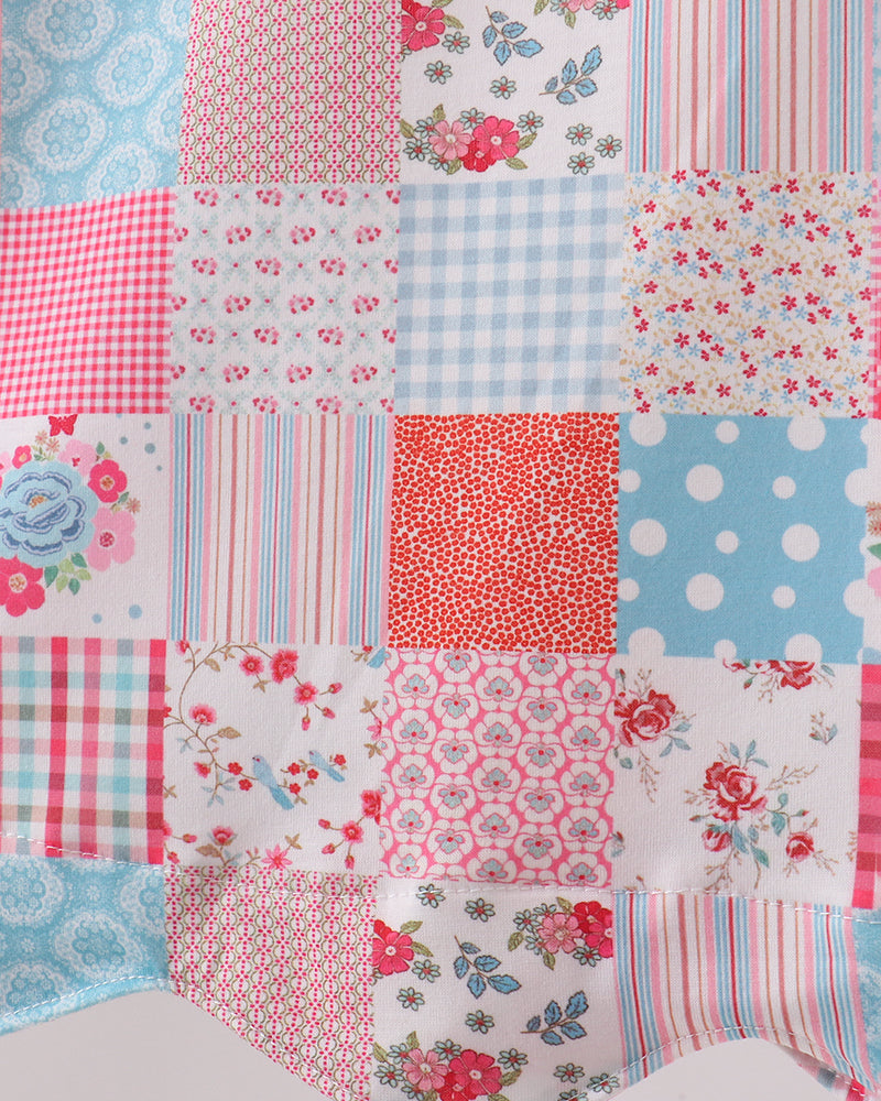 Patchwork dress with floral and polka dot patterns in red, blue, and white.