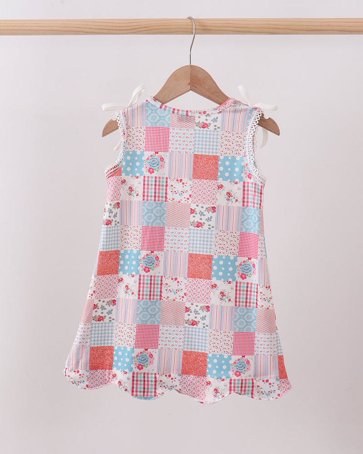 Patchwork dress on a hanger against a white background