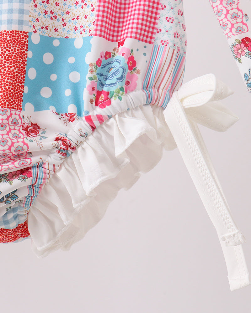 Colorful patchwork rashguard with ruffles on a light background