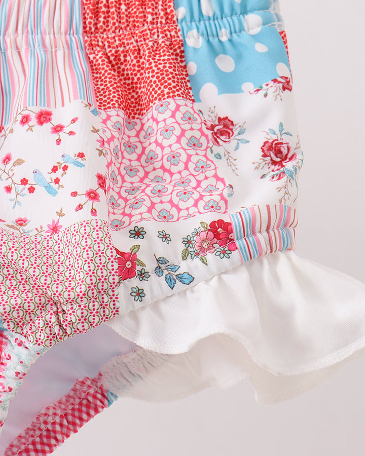 Patchwork swimsuit with floral and polka dot patterns on a white background