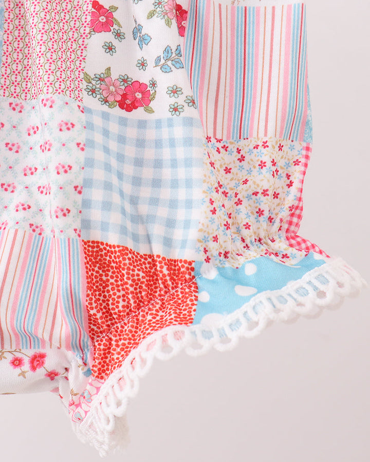 Patchwork fabric with floral, striped, and checkered patterns on a light background