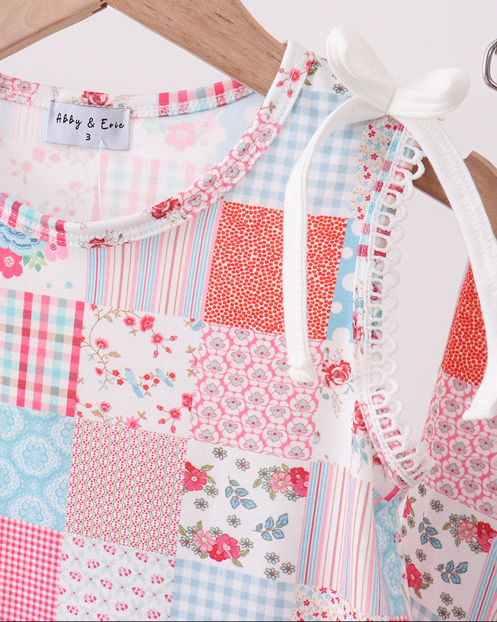 Dress with patchwork pattern on a wooden hanger