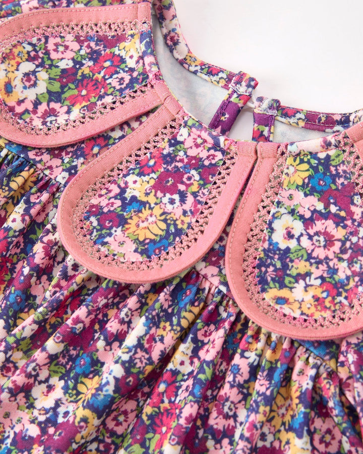 Floral girls dress neckline with pink scalloped collar and loop button placket