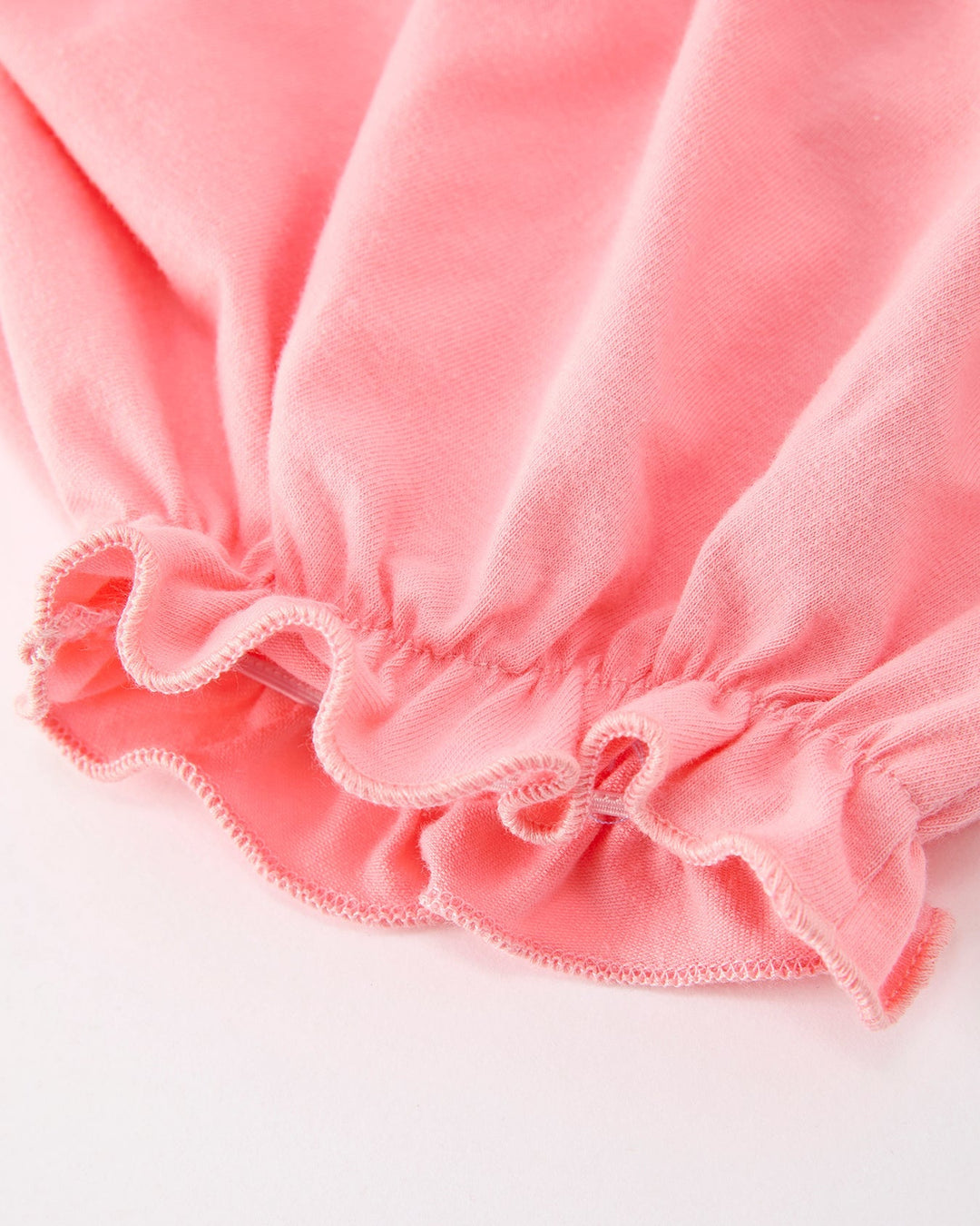 Pink ruffled baby bloomers with elastic waistband
