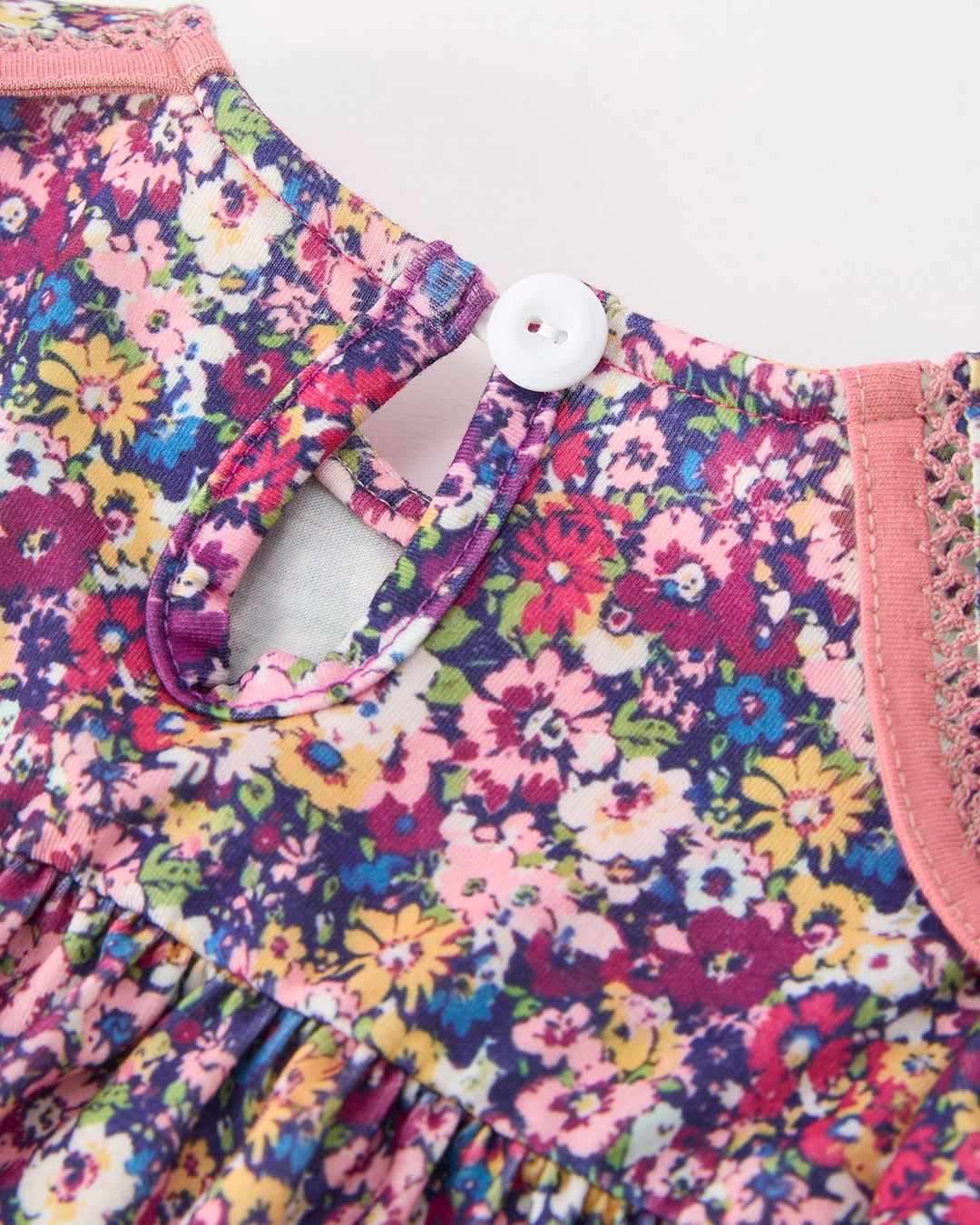 Floral girls dress back with keyhole button and pink button placket detail