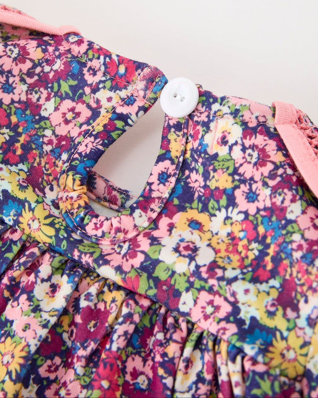 Girls floral dress neckline with button closure and Peter Pan petal collar