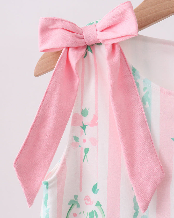Close-up of a pink bow with floral patterns on a white background