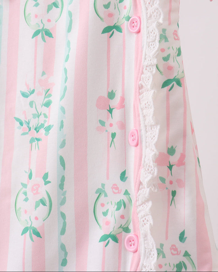 Pink floral patterned fabric with buttons on a white background