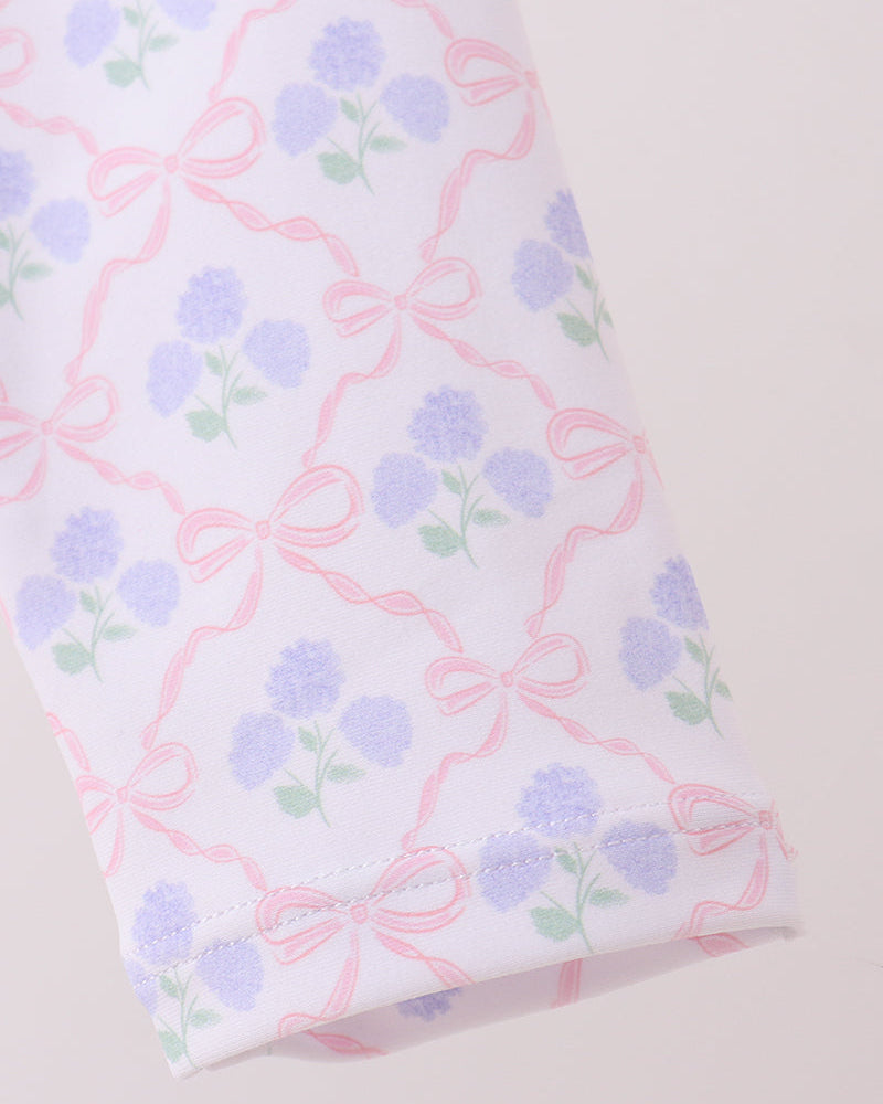 Fabric with floral and bow pattern on a white background