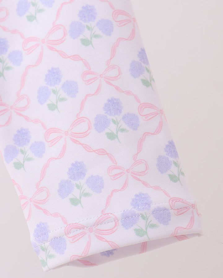 Fabric with floral and bow pattern on a white background