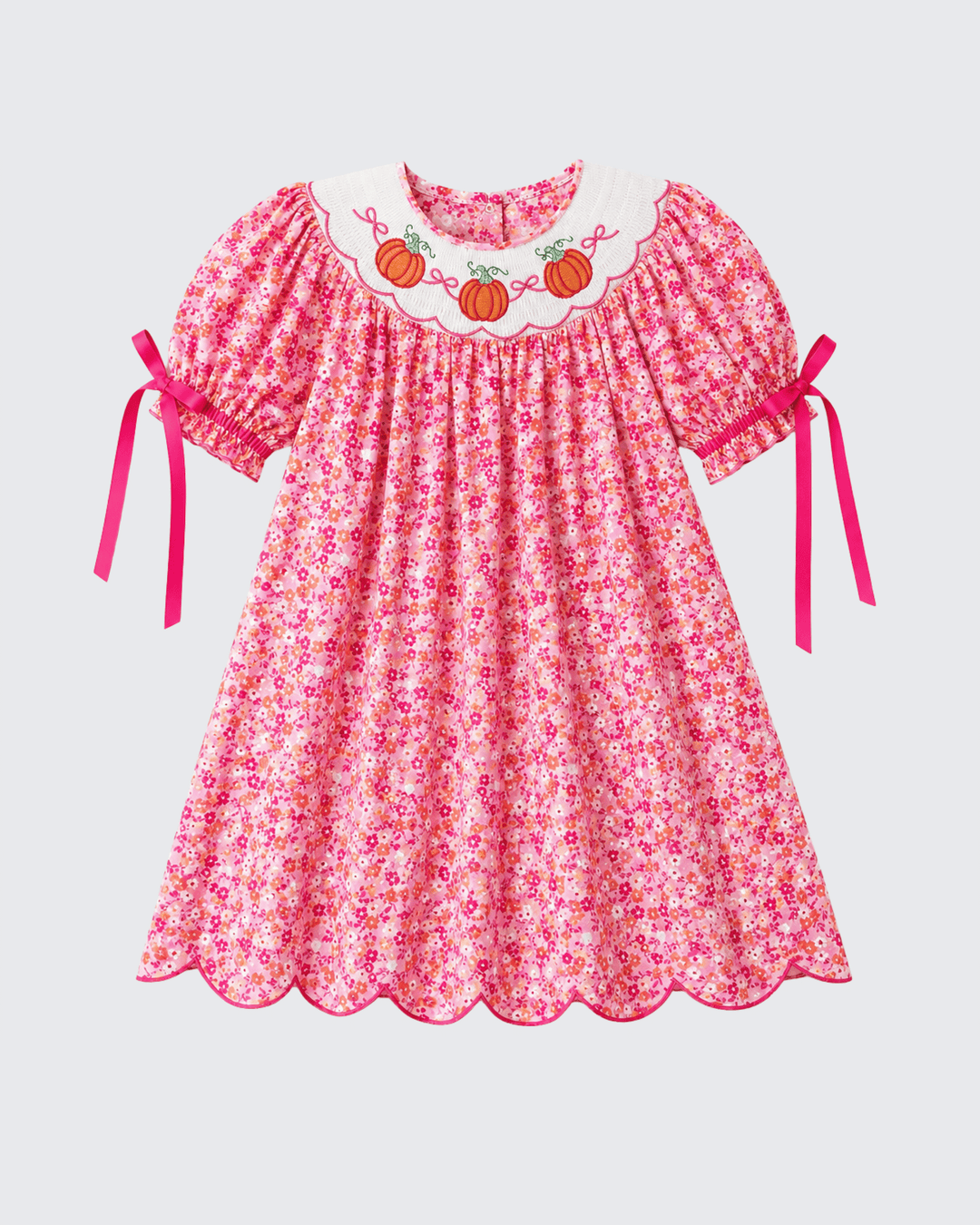 Pink floral twirl dress with pumpkin embroidered collar and short sleeves with bow ties