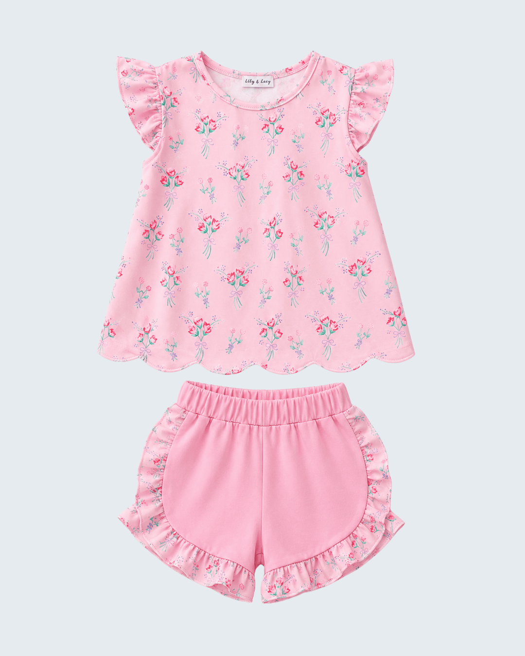 Pink floral top and shorts set on a light gray background