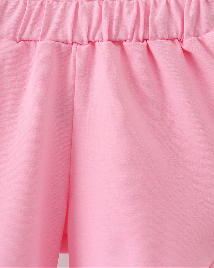 Close-up of pink fabric with a wooden surface in the background